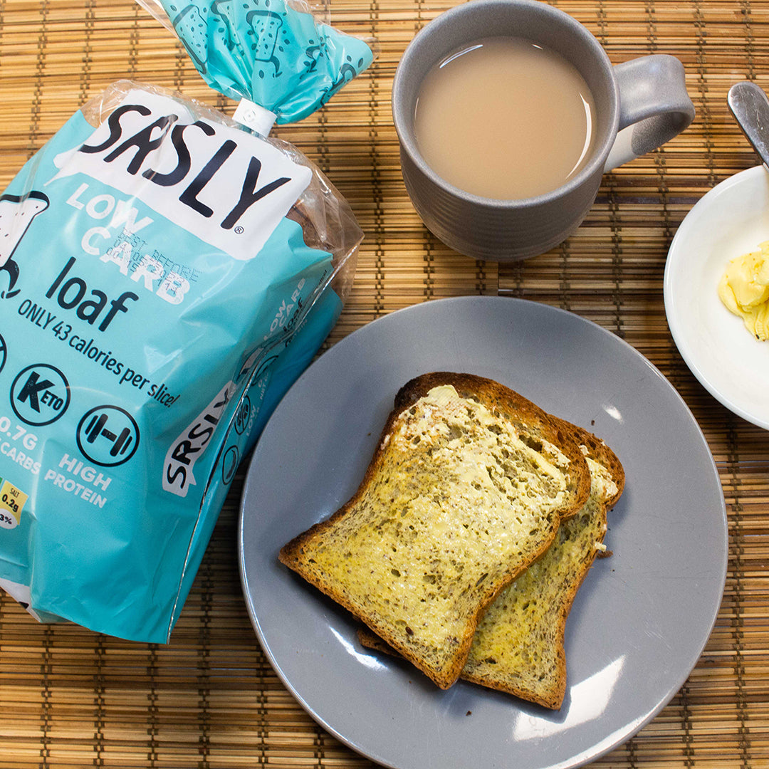 Picture - Low carb bread toasted with melted butter on it. On a plate next to lovely cup of tea, making an ideal low carb tea time treat. 
